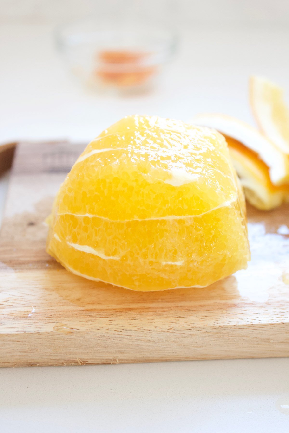 Navel orange peeled on a cutting board 