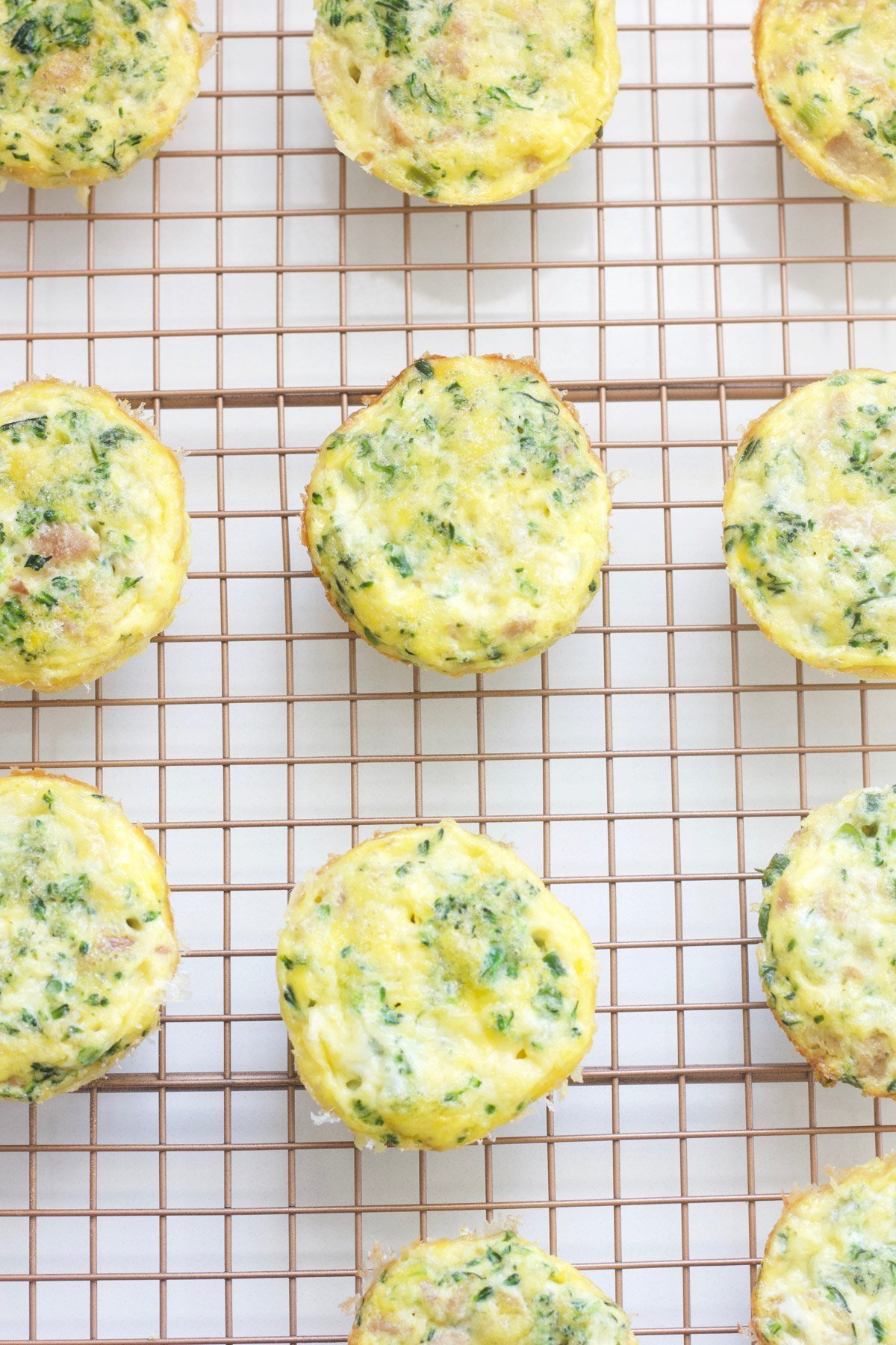 Mini broccoli cheese frittatas on a cooling rack