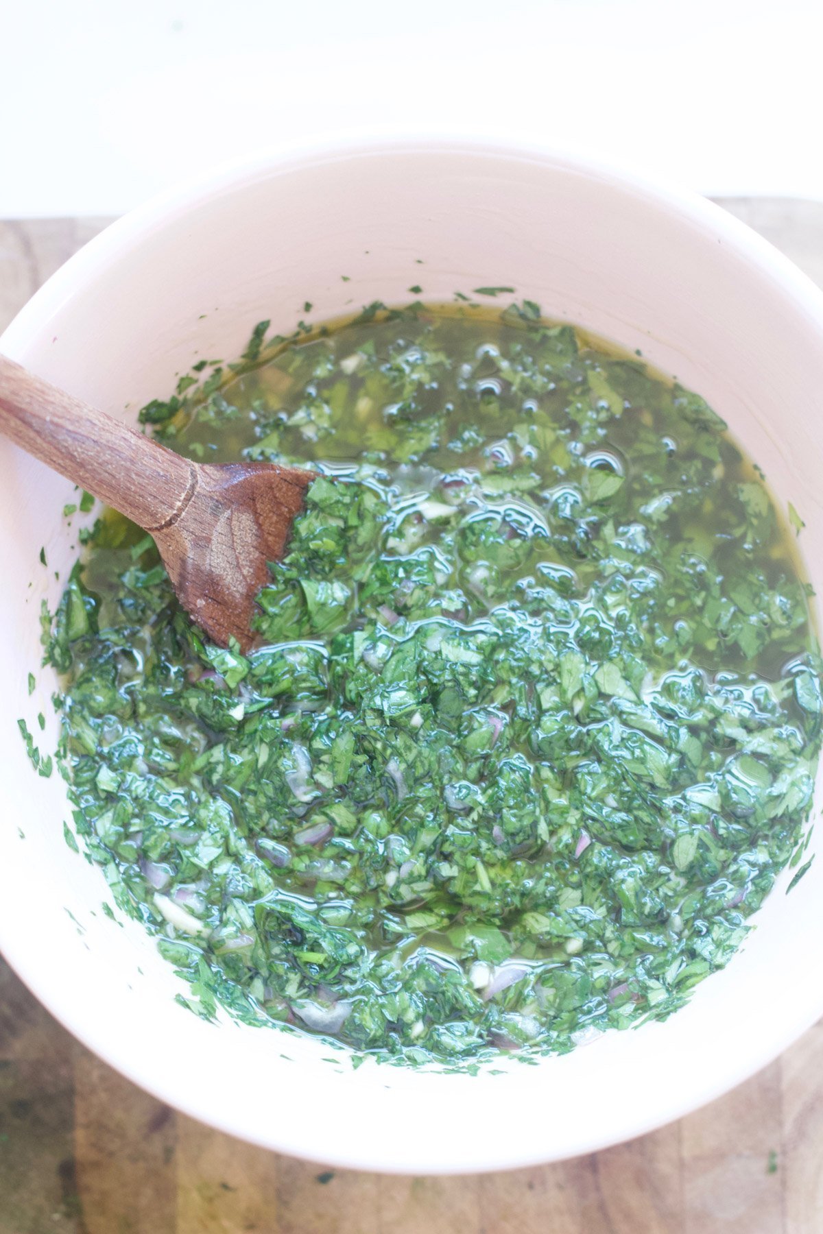 Chimichurri sauce in a pink bowl 