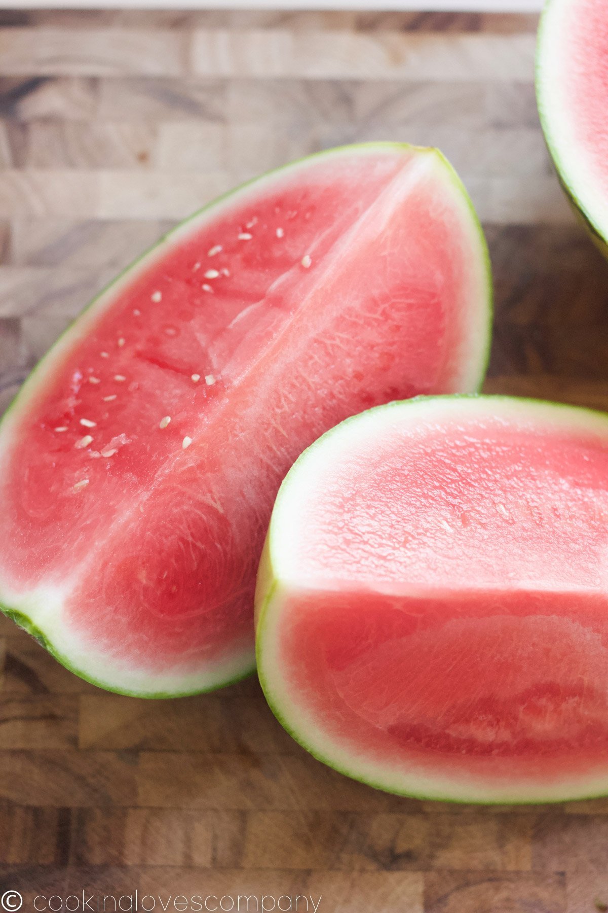 Quartered watermelon on a cutting board