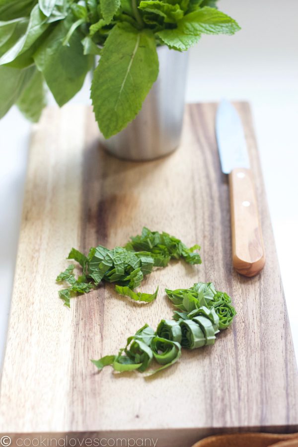 Basil and mint chiffonade on a cutting board