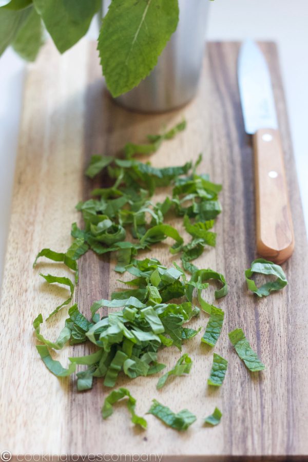 Basil and mint chiffonade on a cutting board