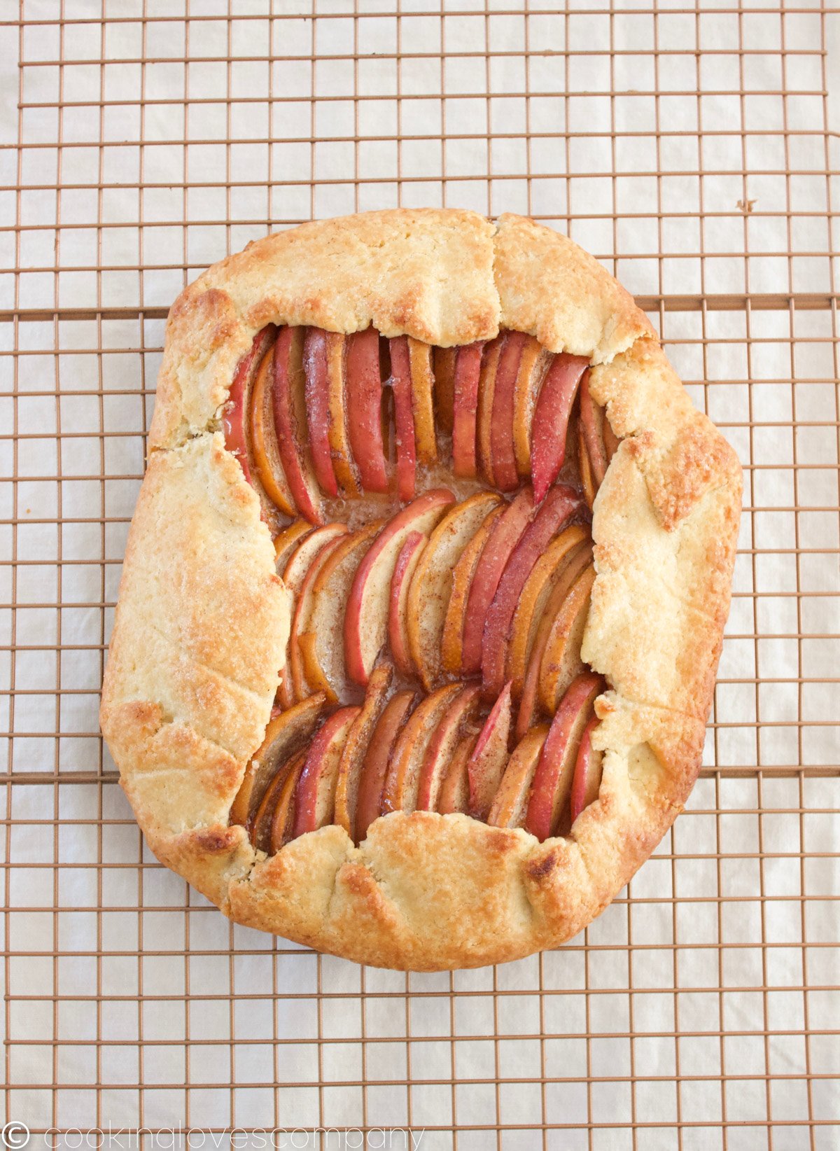 Cooked apple and pear galette on a cooling rack