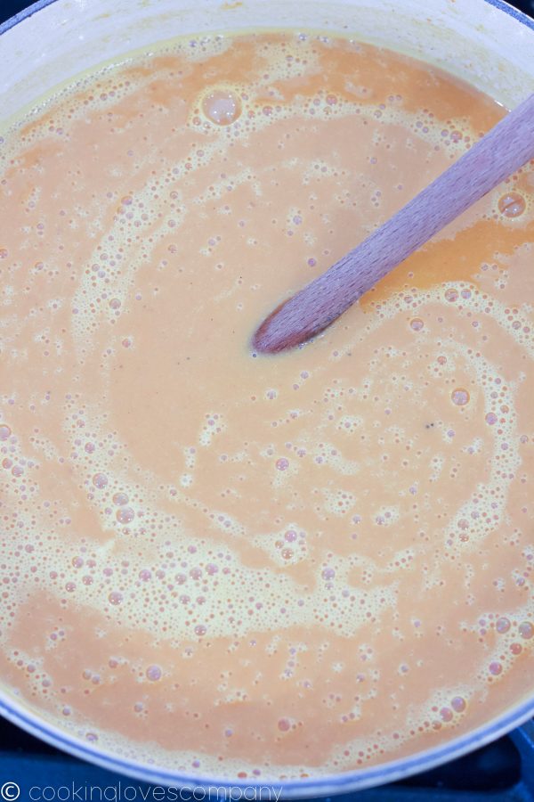 Close up of a dutch oven with pureed pumpkin soup