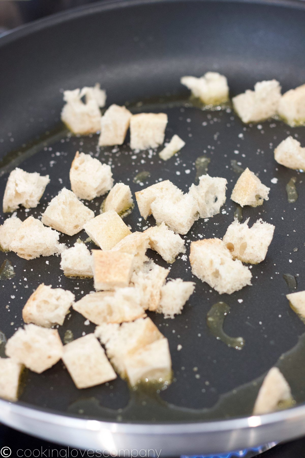 Close up of croutons being cooked in a skillet