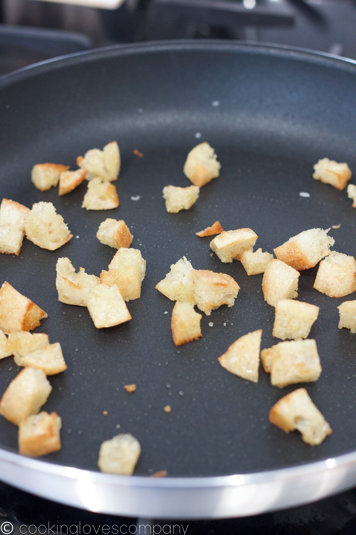 Close up of browned croutons in a skillet